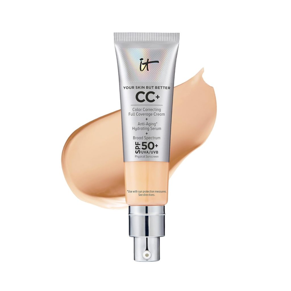 A tube of IT Cosmetics CC+ Cream with SPF 50+ is elegantly displayed on a light cream background. The sleek silver tube, available on Amazon Prime, boasts a pump dispenser and highlights its impressive color correcting and anti-aging properties.