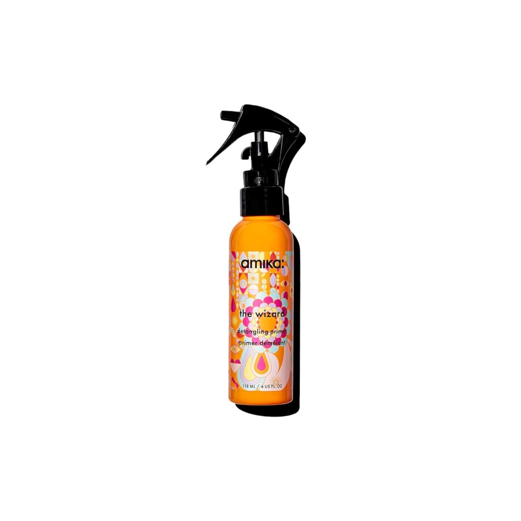 Bottle of Amika The Wizard detangling primer featuring an eye-catching orange and pink design with a spray nozzle, available on Amazon Prime, set against a pristine white background.