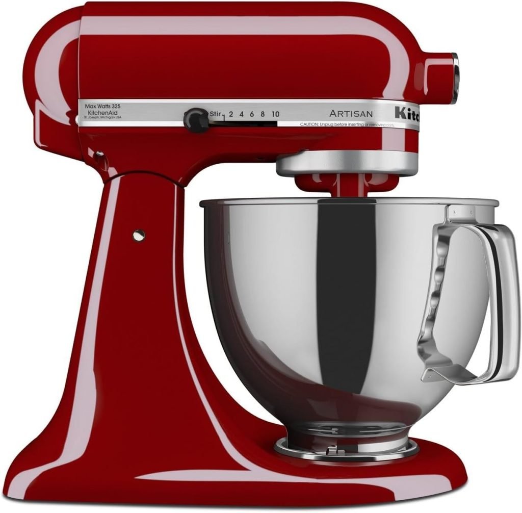 Red KitchenAid stand mixer with a shiny metal bowl attached.