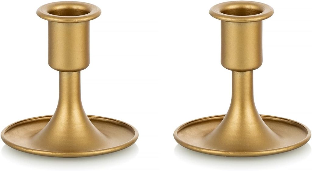 Two identical brass candle holders with a simple, smooth design are shown against a plain white background.