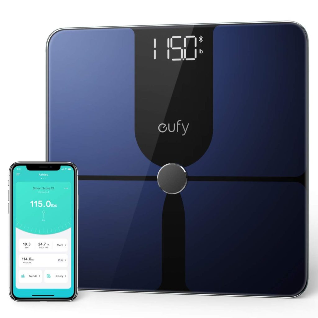 A digital scale showing 115.0 pounds sits beside a smartphone synced to display the same weight, ready for purchase with Amazon Prime.