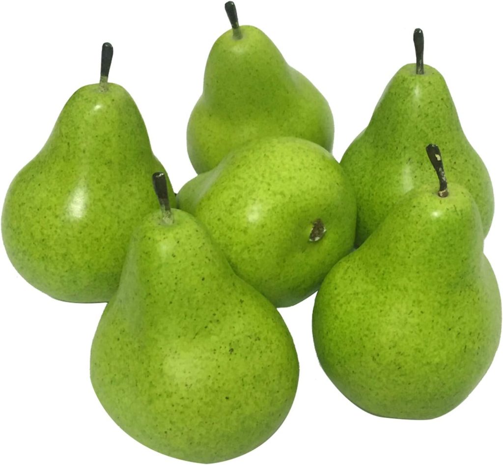 Six green pears are arranged in a group, mirroring the elegance of glass water bottles on a sunlit kitchen counter.