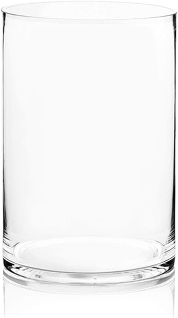 A clear, empty glass cup stands elegantly on a white background, reminiscent of sleek glass water bottles.