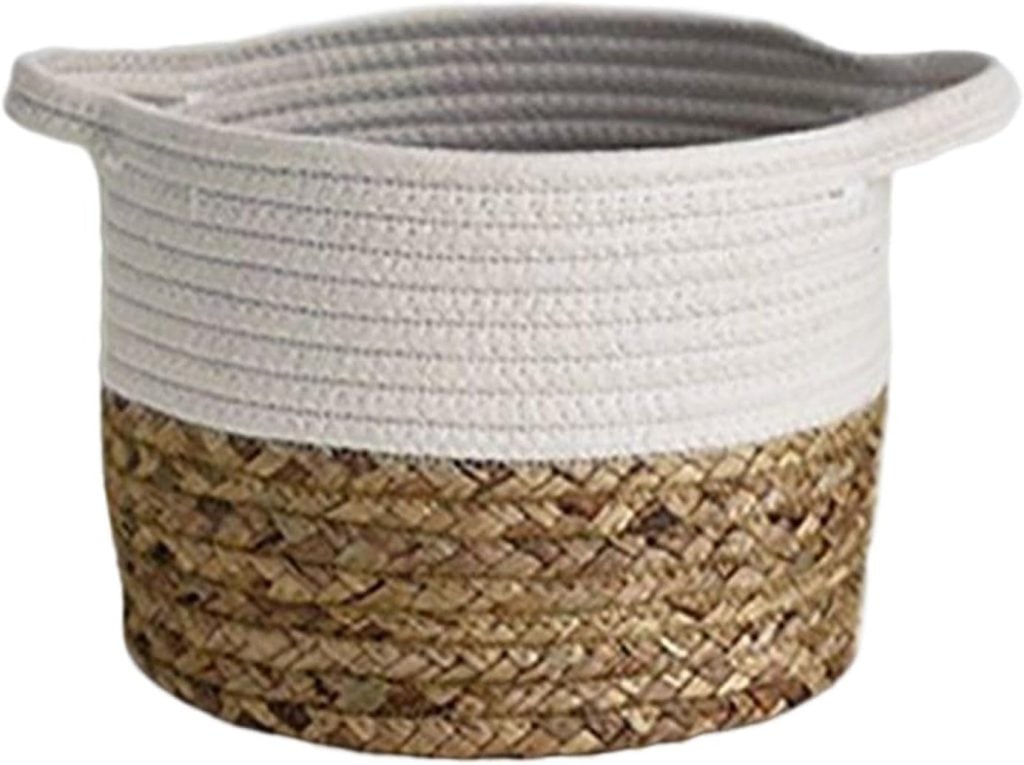 A round woven basket with a white top half and a brown, natural fiber bottom half.