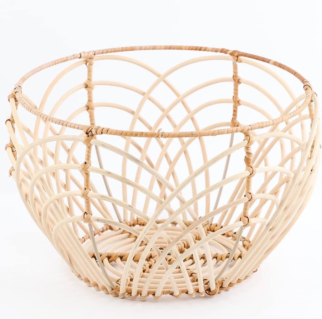 A round, open-weave rattan basket with intersecting curved lines, in the signature Serena and Lily style, displayed on a plain white background.