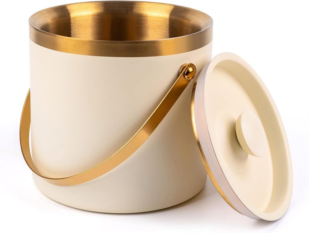 A cream and gold-colored ice bucket with a handle, shown with its matching lid resting to the side, pairs beautifully with elegant glass water bottles for stylish entertaining.