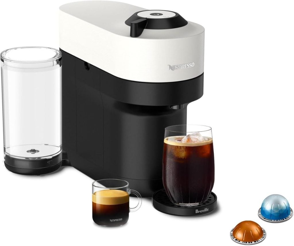 A Nespresso coffee machine, available on Amazon Prime, sits next to two brewed coffee cups—one iced and one espresso—alongside three tempting coffee pods.