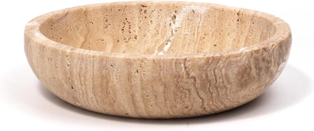 A round, beige stone bowl with a smooth, polished surface and natural texture.