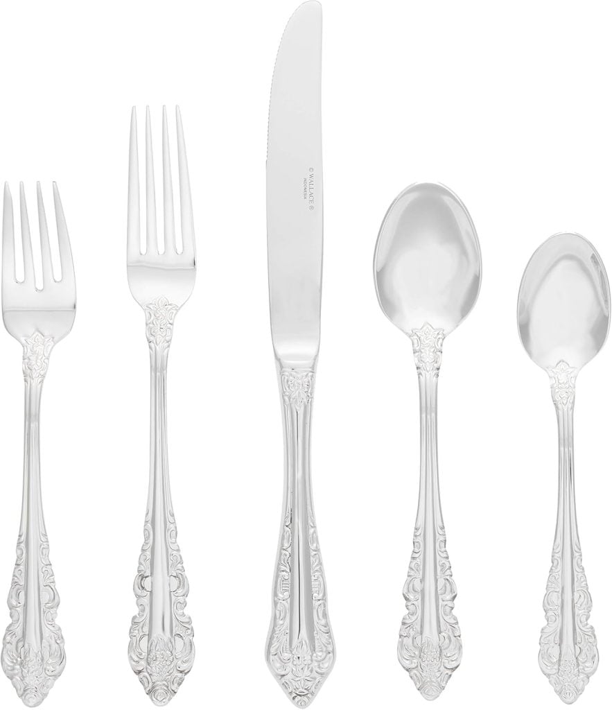 A set of five ornate silver utensils—two forks, one knife, and two spoons—arranged in a row on a white background, perfect for your elegant Friendsgiving table setting.