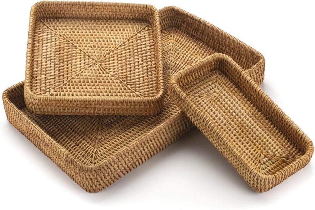 Four stacked rectangular woven baskets of varying sizes are arranged on a white background.