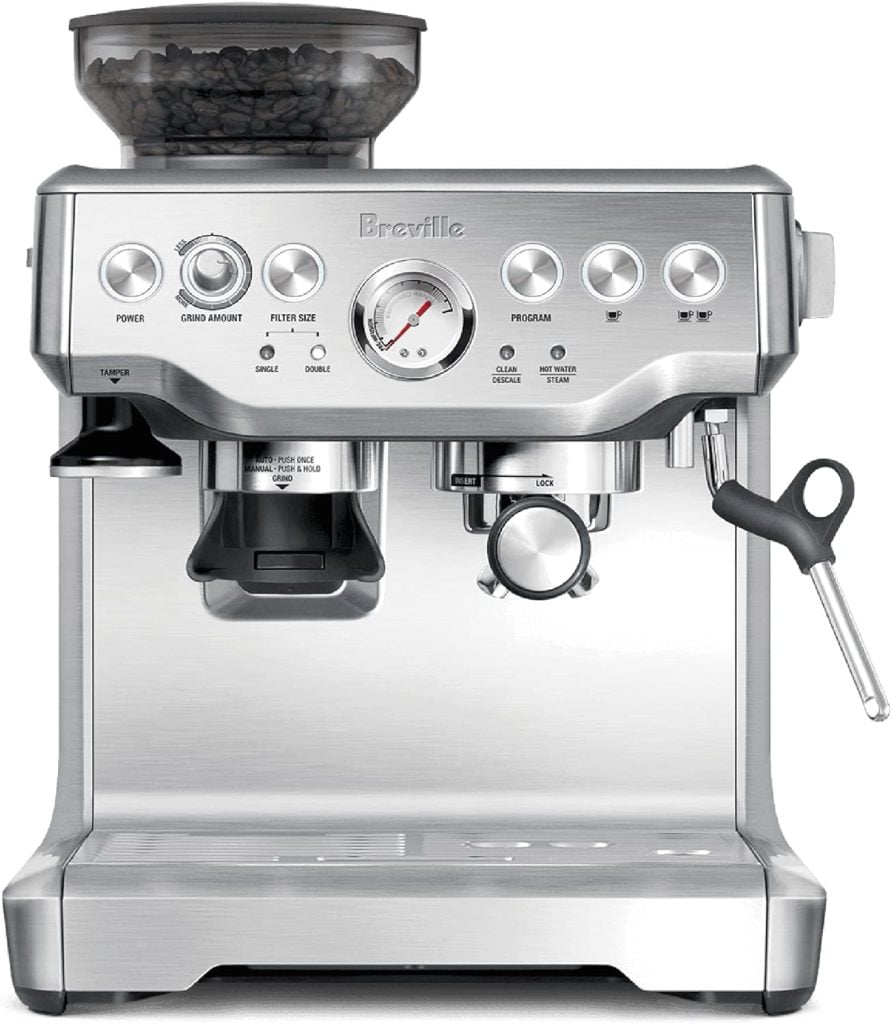 A silver espresso machine with a built-in grinder and visible bean hopper on top. It has a steam wand, gauge, and various control buttons.