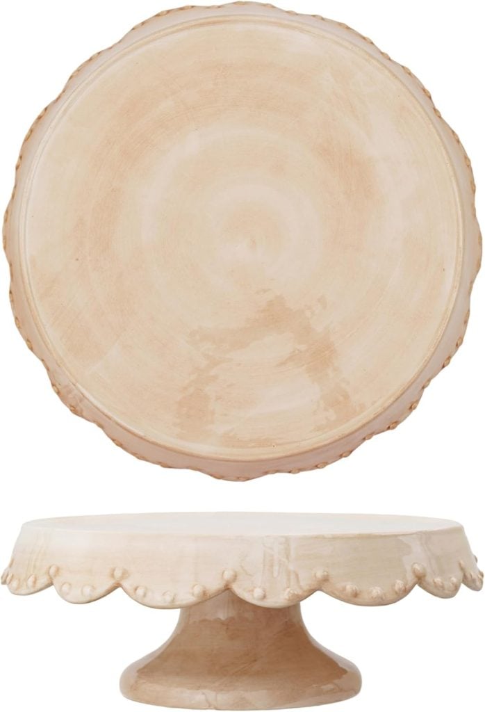 A beige ceramic cake stand with a scalloped edge and round base, shown from the top and side angles—perfect for displaying a sourdough pie crust or your favorite desserts.