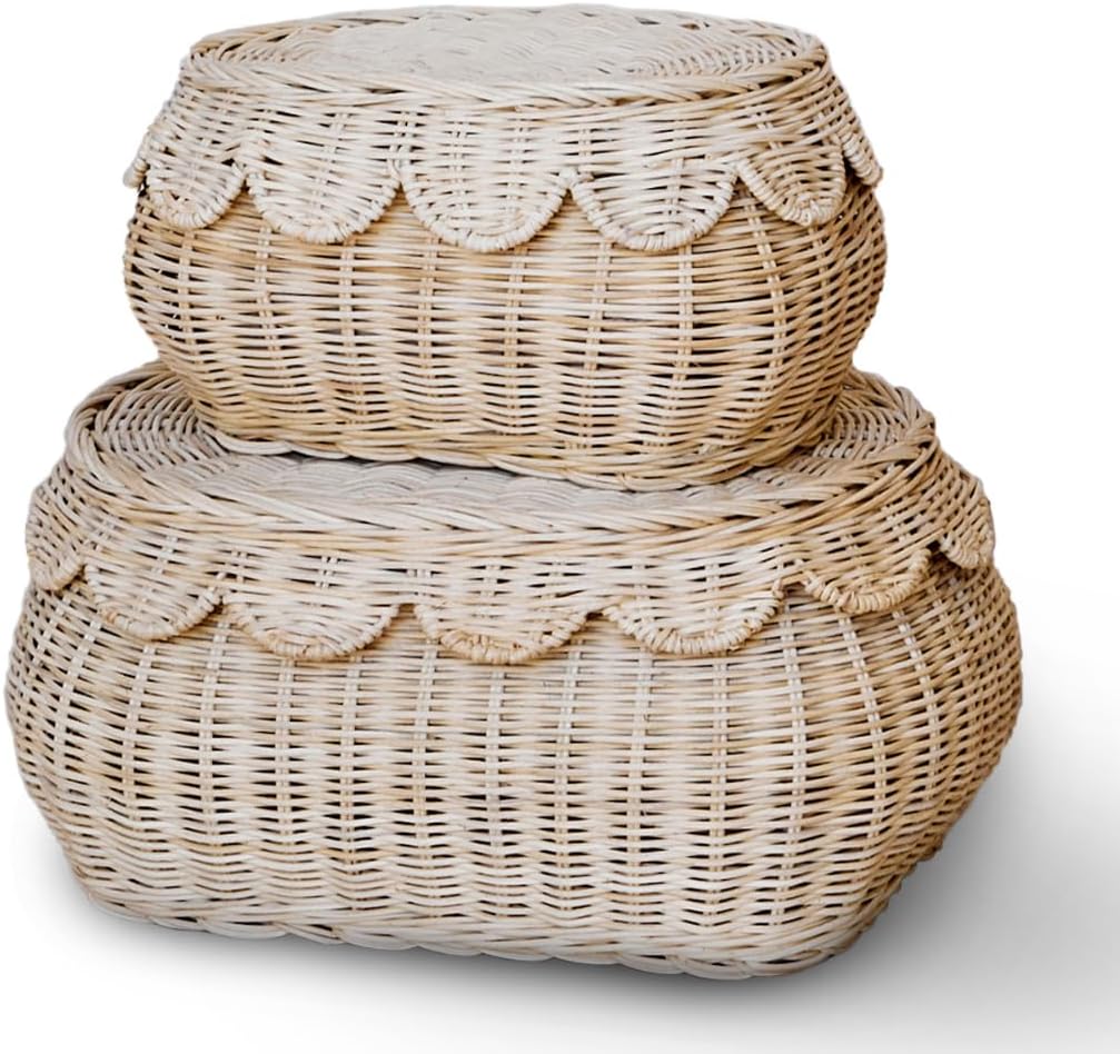 Two round, woven rattan baskets stacked on top of each other. The top basket is smaller with scalloped edges, while the bottom one is larger and flat-topped. Both baskets are light in color.