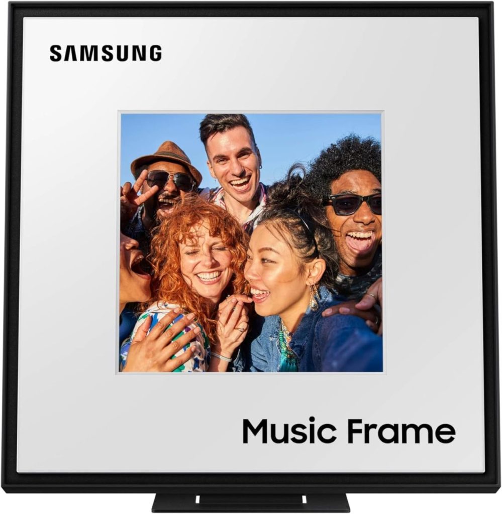 The Samsung Music Frame showcases an Amazon Prime-worthy moment with a group of six people smiling and posing for a selfie against a vibrant blue sky background.