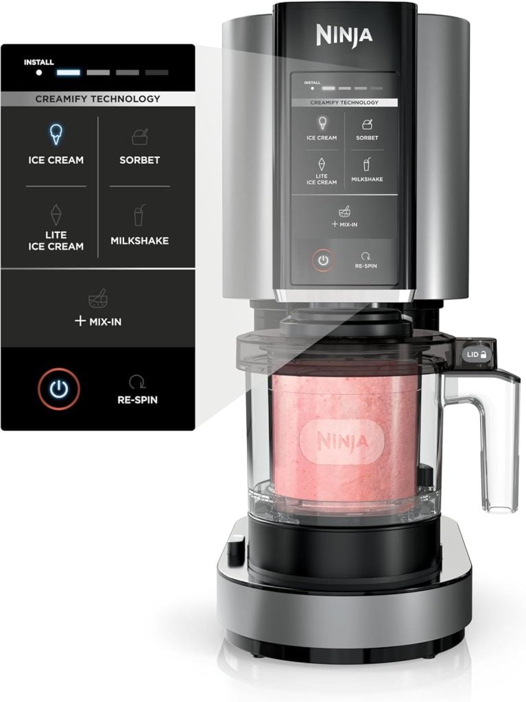 A Ninja ice cream maker with digital controls offers options for ice cream, sorbet, milkshake, and mix-ins. Available on Amazon Prime, it features a container with pink frozen dessert inside the machine.