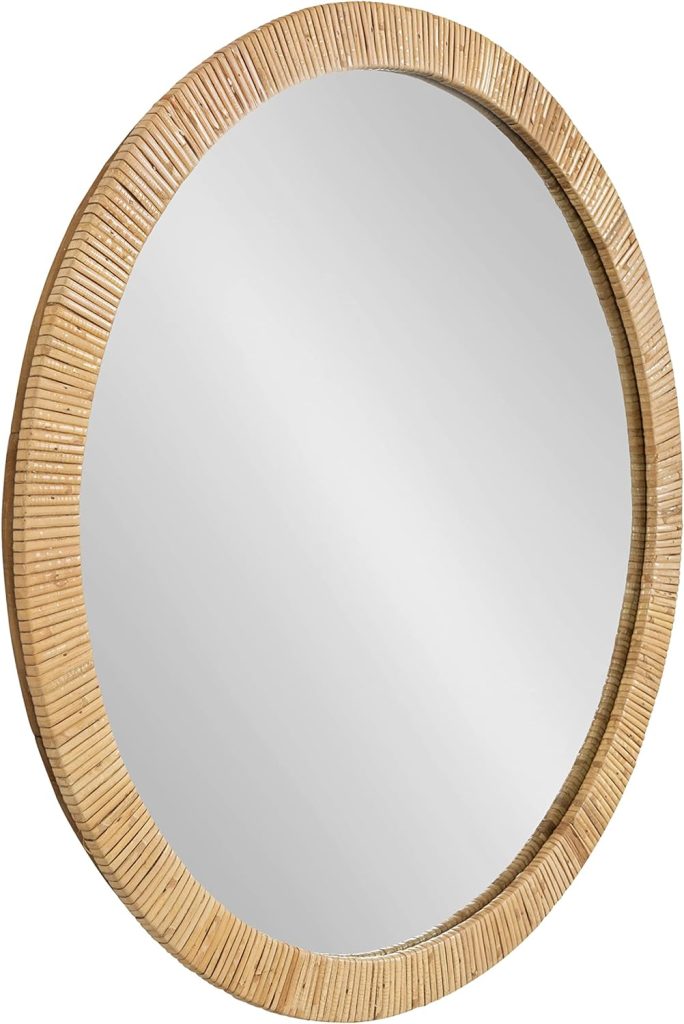 A round mirror with a textured, light brown, woven frame.