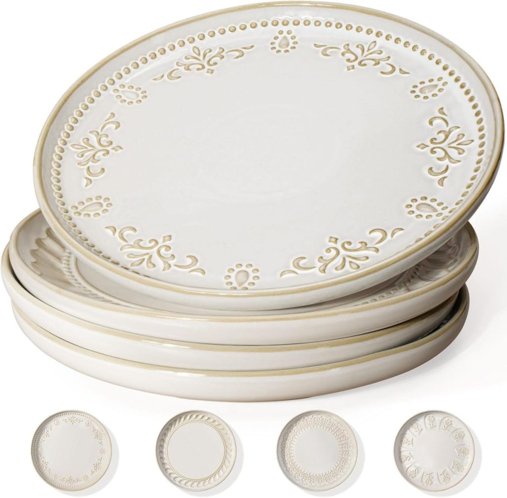 A stack of five decorative white ceramic dinner plates, perfect as Thanksgiving plates, featuring intricate embossed patterns around the edges.