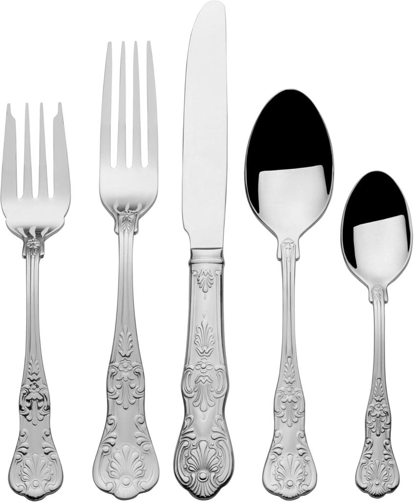 A set of five ornate silver utensils, including two forks, a knife, a large spoon, and a small spoon, gracefully arranged vertically on a white background. Perfect for adorning your Thanksgiving plates with elegance.