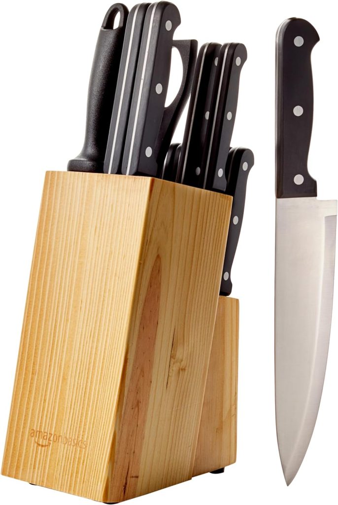 A wooden knife block containing a set of black-handled knives with stainless steel blades and one large knife placed beside the block, perfect for preparing your favorite recipes, like baked brie with jam.