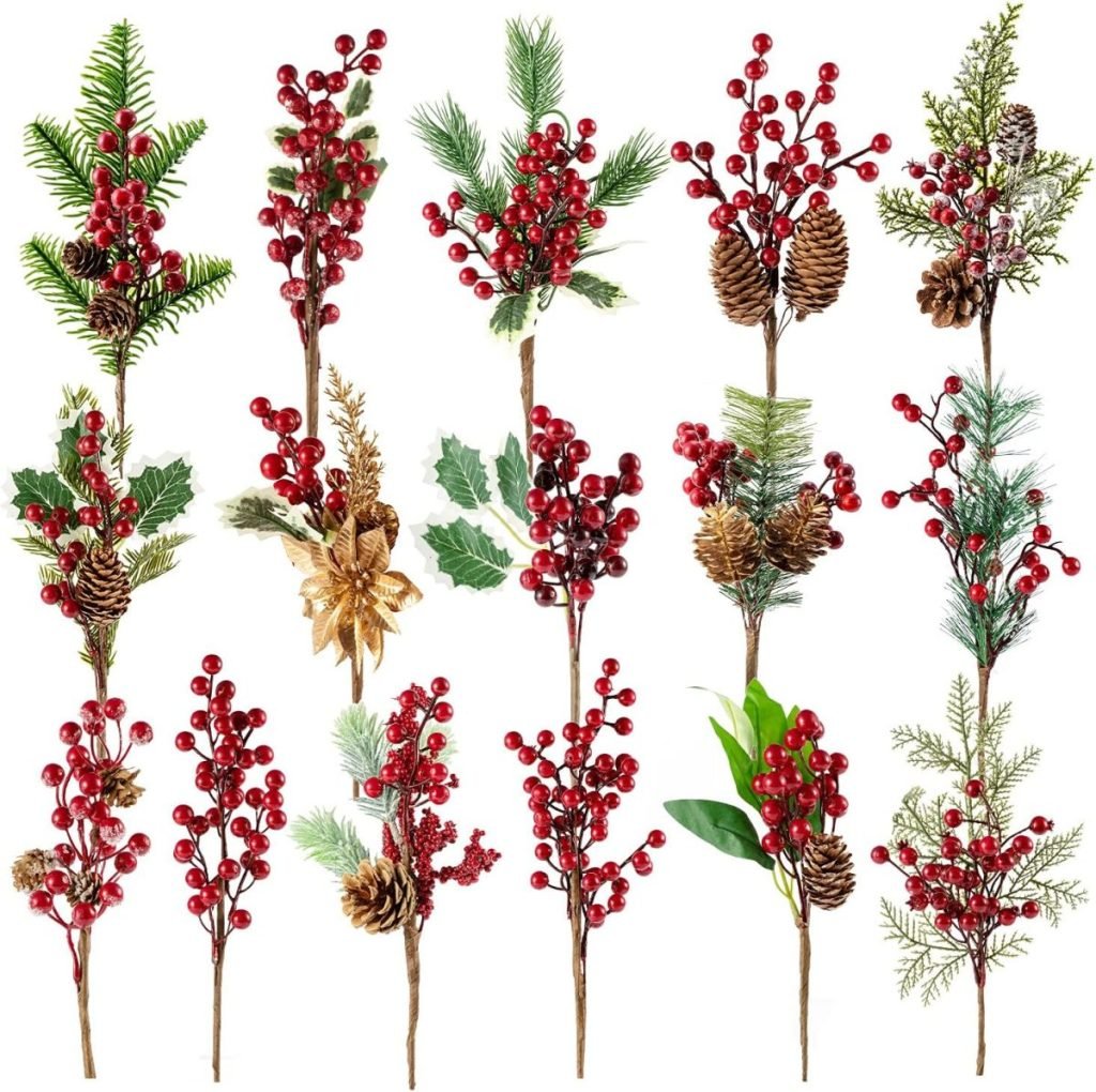 Various festive sprigs with red berries, pine cones, and greenery are arranged in rows against a white background.