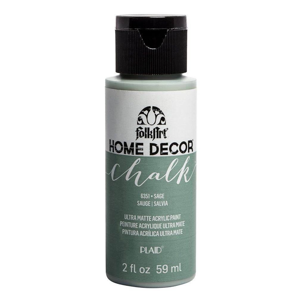 A 2 fl oz bottle of FolkArt Home Decor Chalk acrylic paint in sage color, with a black cap and product information on the label.