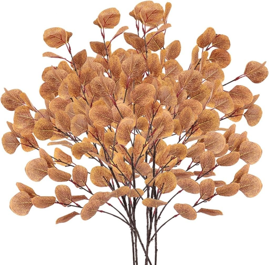 A bouquet of artificial branches with small, round, textured leaves in shades of brown and orange.