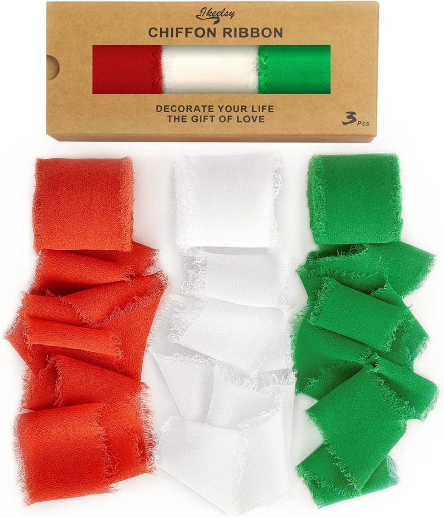 A box labeled "Chiffon Ribbon" contains rolls of red, white, and green ribbon. Three pieces are shown: one red, one white, and one green, each with a frayed edge.