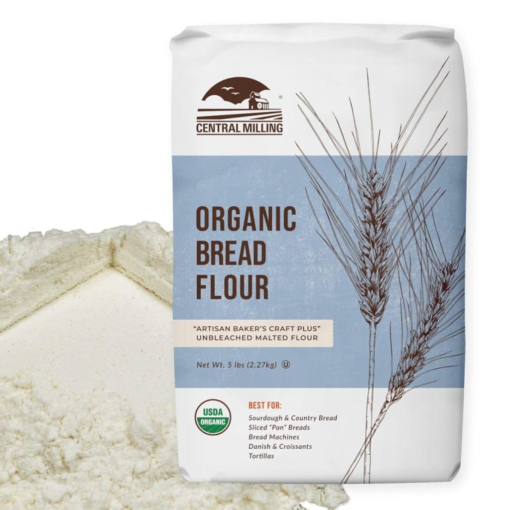 Bag of Central Milling organic bread flour next to a small mound of flour.