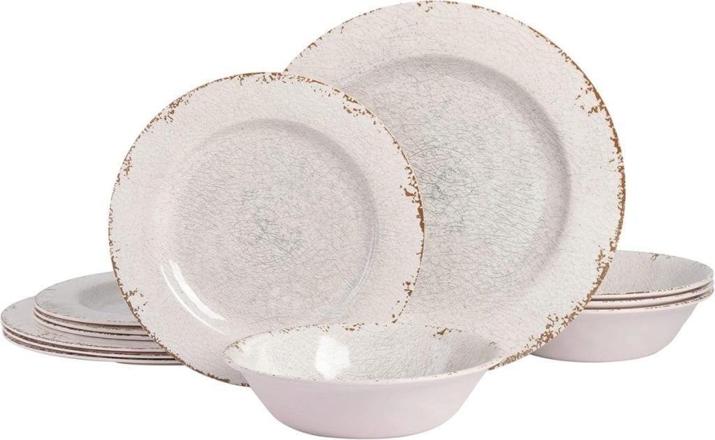 A set of crackle-glazed dishes, including plates and bowls, stacked together. The edges appear slightly worn or weathered, reminiscent of enjoying pie for breakfast on a lazy morning.