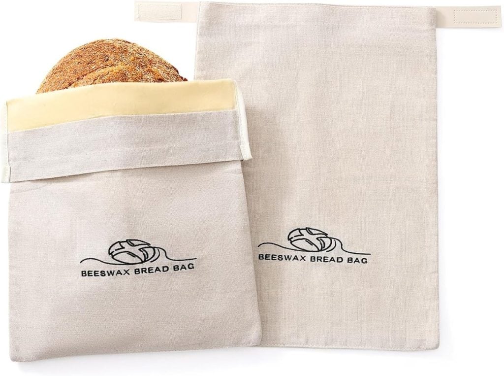 Two beeswax bread bags, one holding a loaf, displayed on a white background.