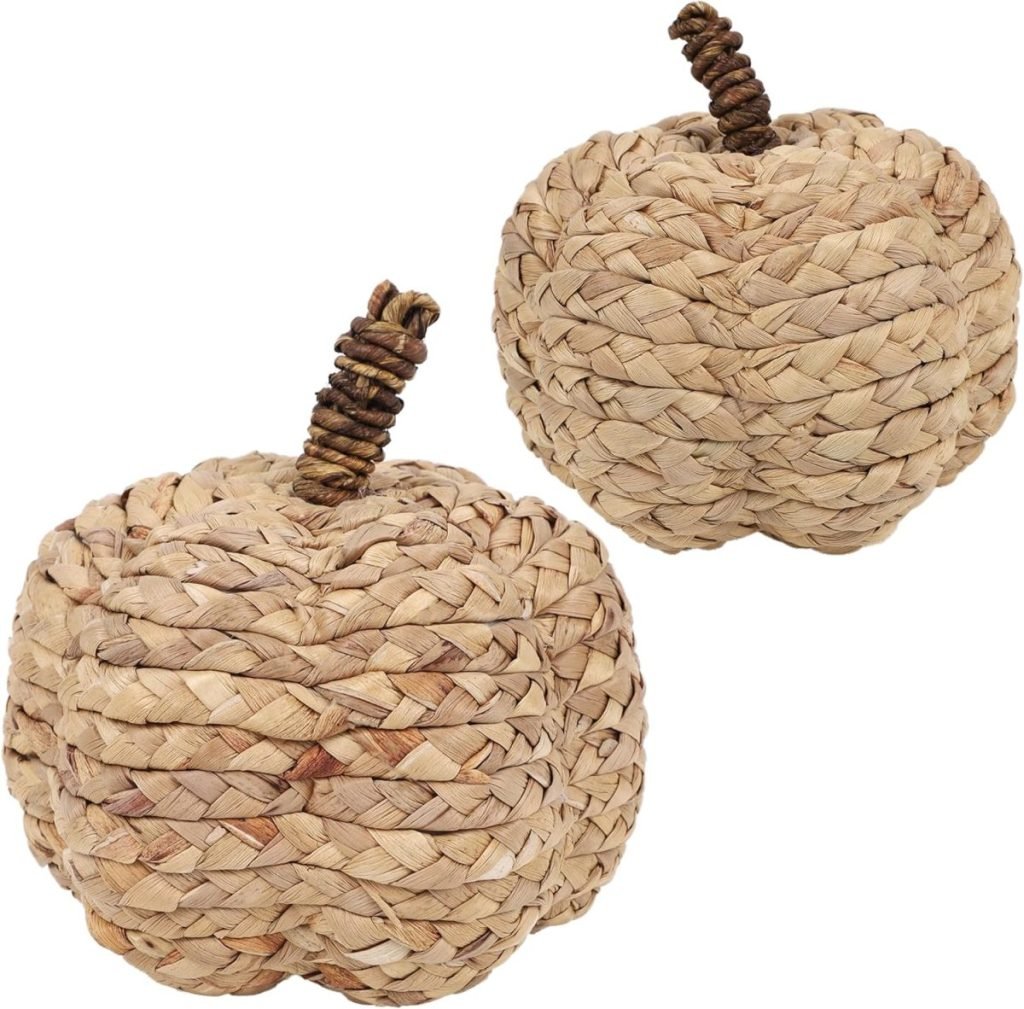 Two decorative pumpkins made of woven straw, featuring twisted stems.