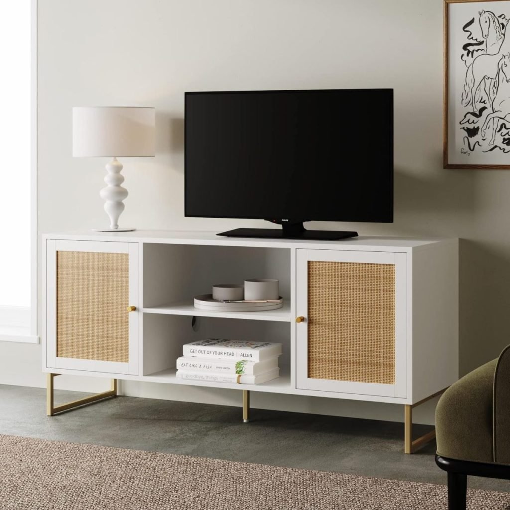 A modern living room setup features a flat-screen TV ready for Amazon Prime streaming, perched on a white cabinet flanked by a white lamp and decorative items. Above the cabinet, a framed abstract artwork adds an artistic flair.