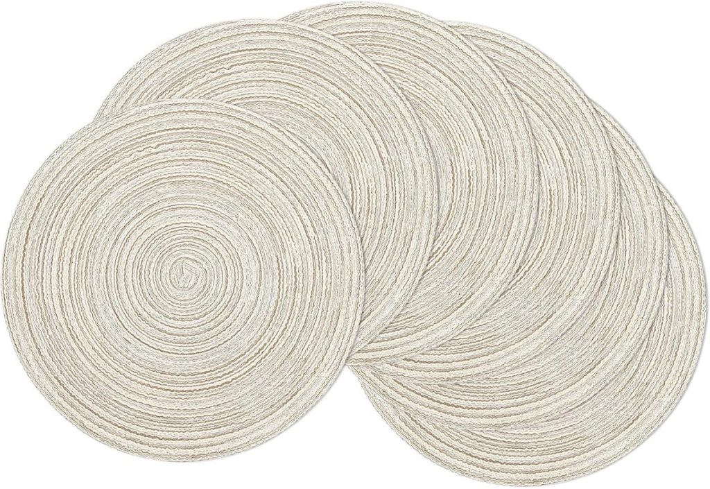 Five overlapping, round, beige braided placemats are arranged, creating a pattern that perfectly complements any Friendsgiving celebration.