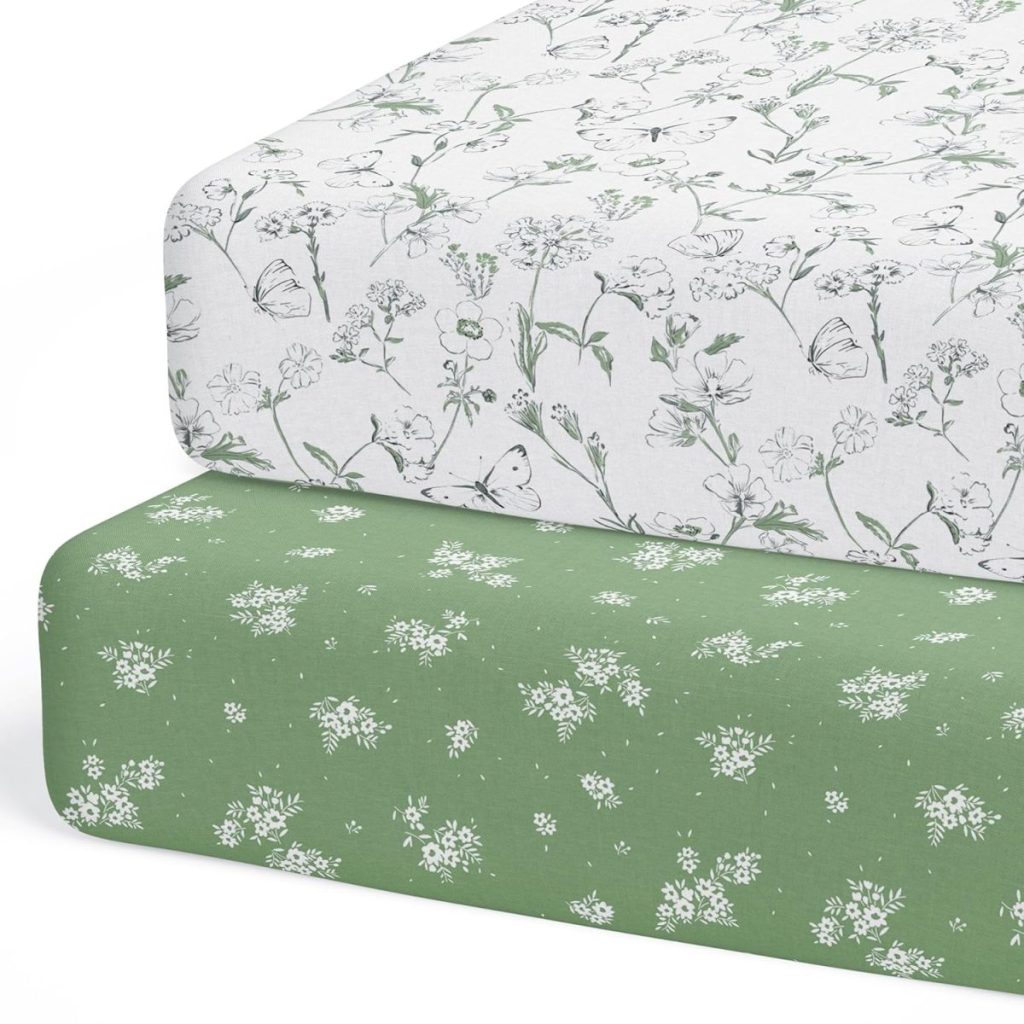 Two folded sheets with floral patterns, one white with green flowers and the other green with white flowers, stacked on top of each other—a perfect touch of elegance delivered swiftly with Amazon Prime.