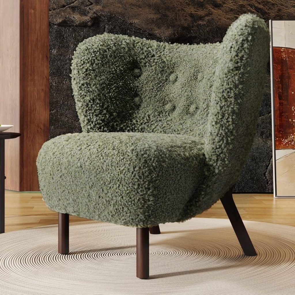 A green, textured armchair with wooden legs is positioned on a circular rug in a modern room with a wooden and stone textured wall in the background.