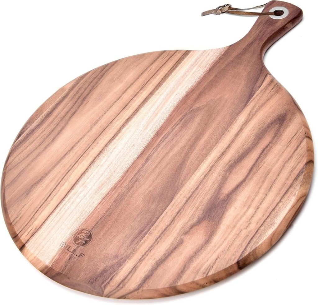 Round wooden cutting board with a handle, showcasing a natural wood grain pattern and a leather strap for hanging. Perfectly complements your Thanksgiving plates for an elegant holiday presentation.