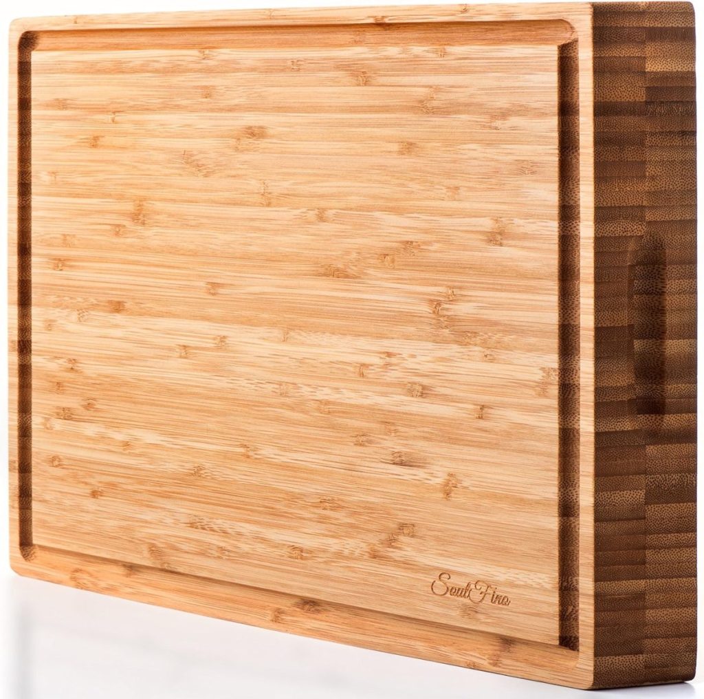 A rectangular wooden cutting board, perfect for your Friendsgiving ideas, features a groove around the edge and a slightly darker edge finish.