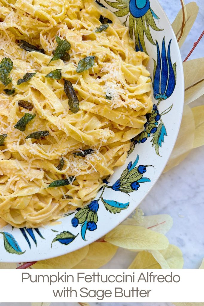 A plate of pumpkin fettuccine Alfredo garnished with sage butter and grated cheese.