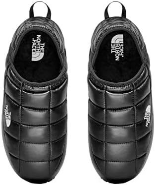A pair of black, quilted slip-on slippers with The North Face logo on the top and side, viewed from above—perfect for keeping your feet cozy on Christmas morning.