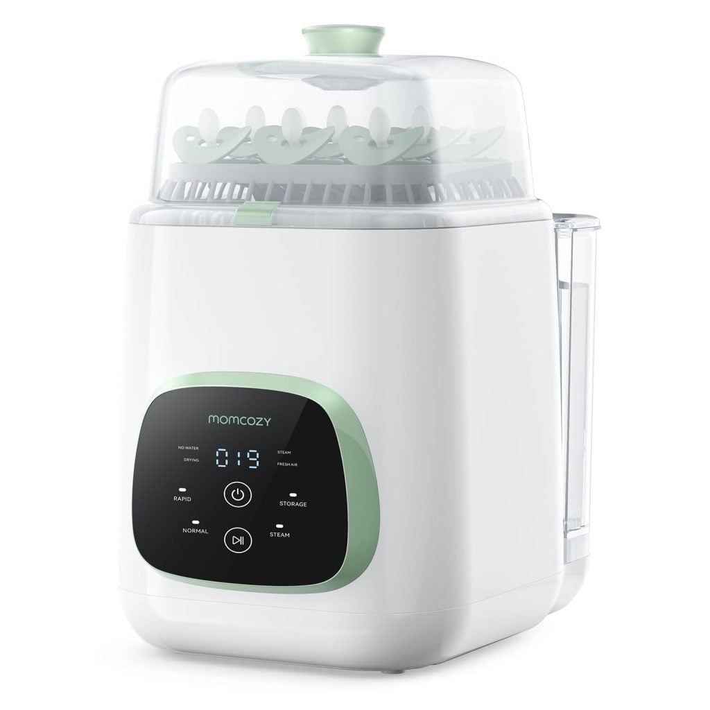 A white and green Momcozy electric baby bottle sterilizer with a digital display and buttons on the front, holding several baby bottles under a clear lid, perfect for busy parents prepping bottles or Classic Christmas Cookies treats.