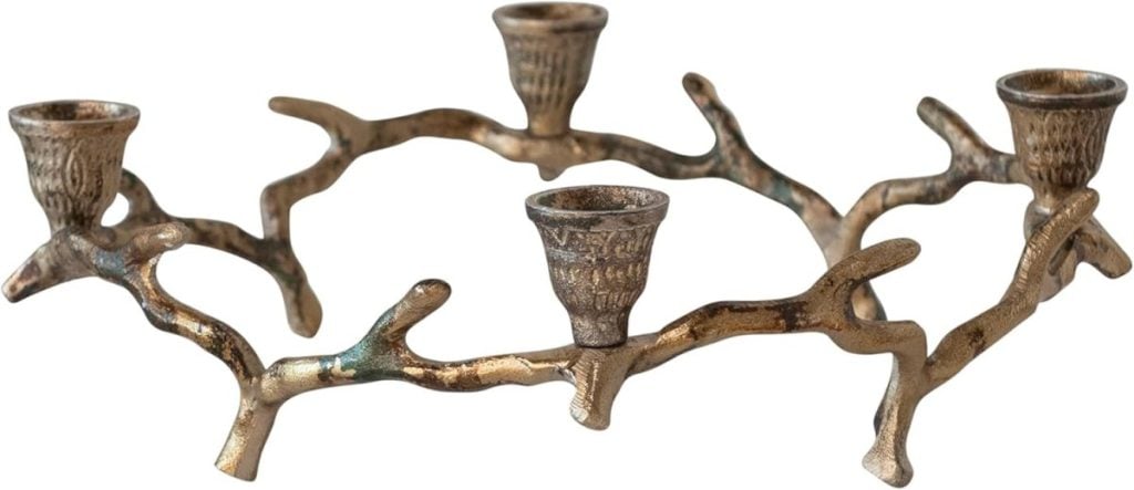 A bronze-colored metal candle holder, designed to look like intertwined tree branches, with four candle slots—perfect for adding a touch of pink Christmas charm to your holiday décor.