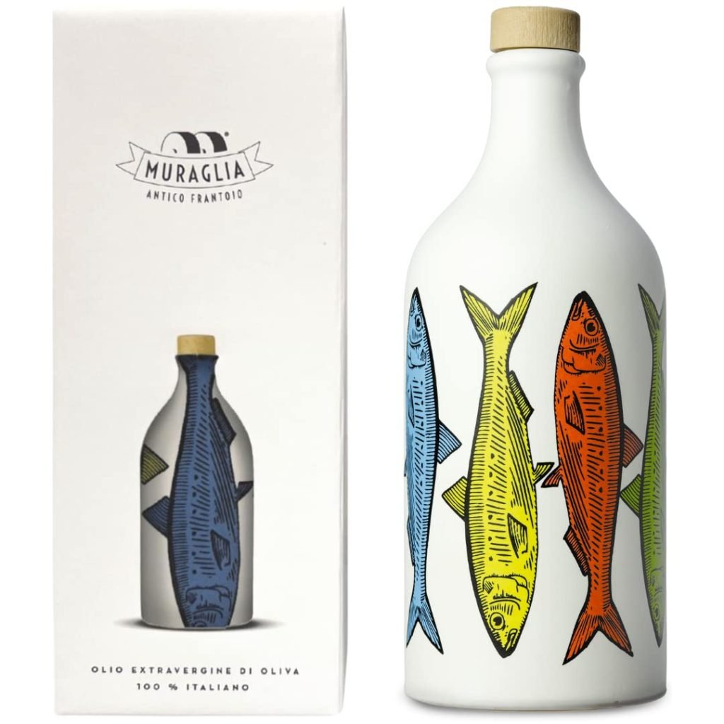 A bottle of Muraglia olive oil with colorful fish illustrations, next to its matching box.