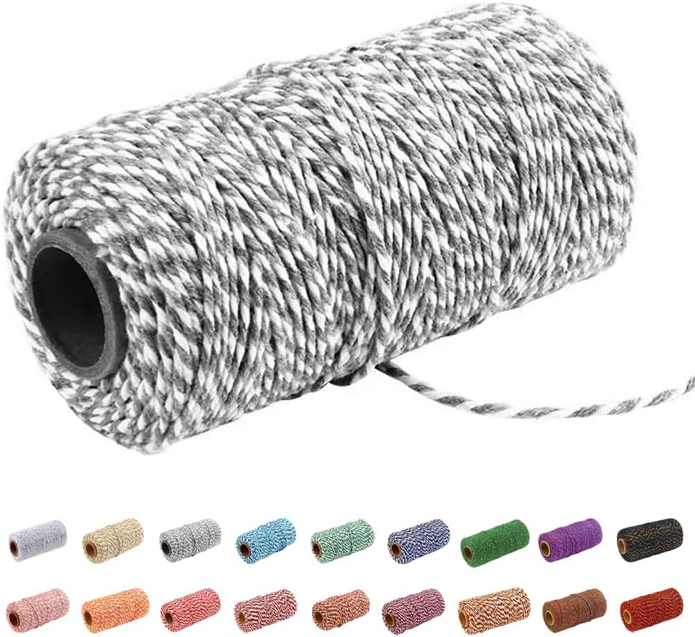 A large spool of black and white twine is displayed, reminiscent of the intricate patterns found on an oyster shell, with smaller spools in various colors shown beneath it.