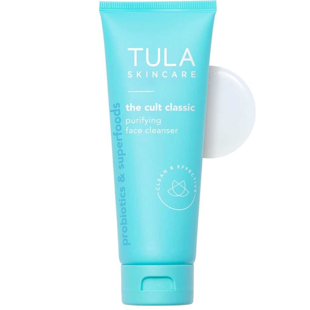 A turquoise tube of Tula Skincare "The Cult Classic" purifying face cleanser, capped in white, stands upright—ready to refresh your skin like Christmas Morning.