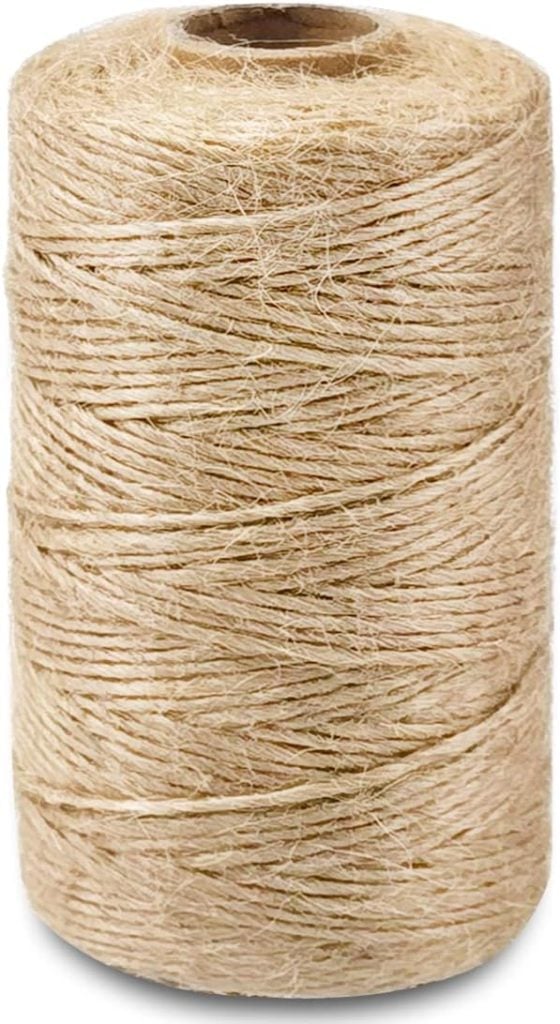 A tall spool of natural jute twine, tightly wound.