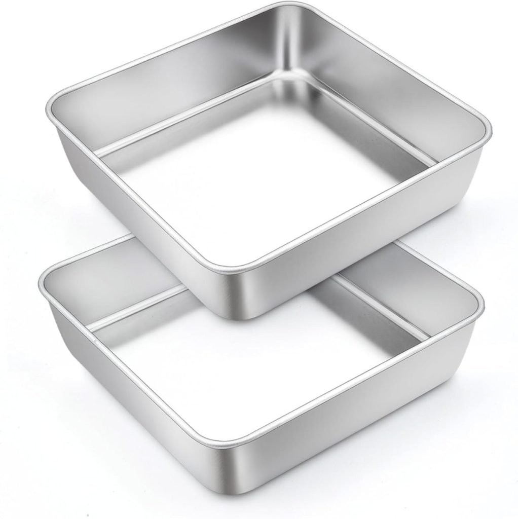 Two stacked square metal baking pans, perfect for crafting your favorite holiday desserts, sit elegantly on a white background.