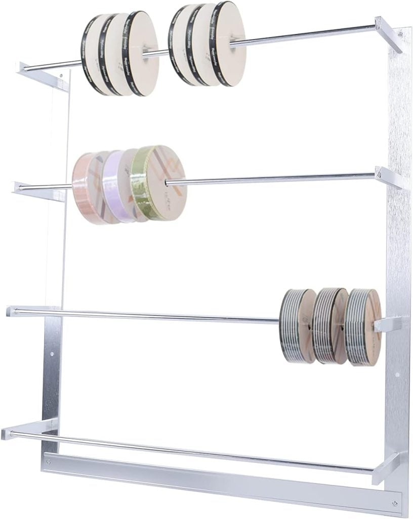 A metal rack with three horizontal rods elegantly holds multiple spools of ribbon, showcasing a delightful array of colors and patterns perfect for gift wrapping.