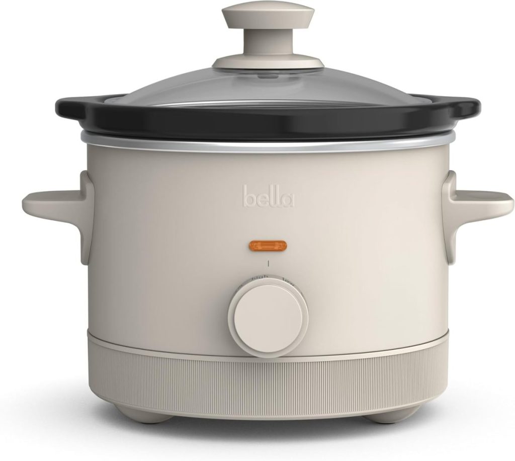 A beige Bella slow cooker with a glass lid, knob control, and indicator light is shown against a white background—perfect for preparing meals during Black Friday sales.