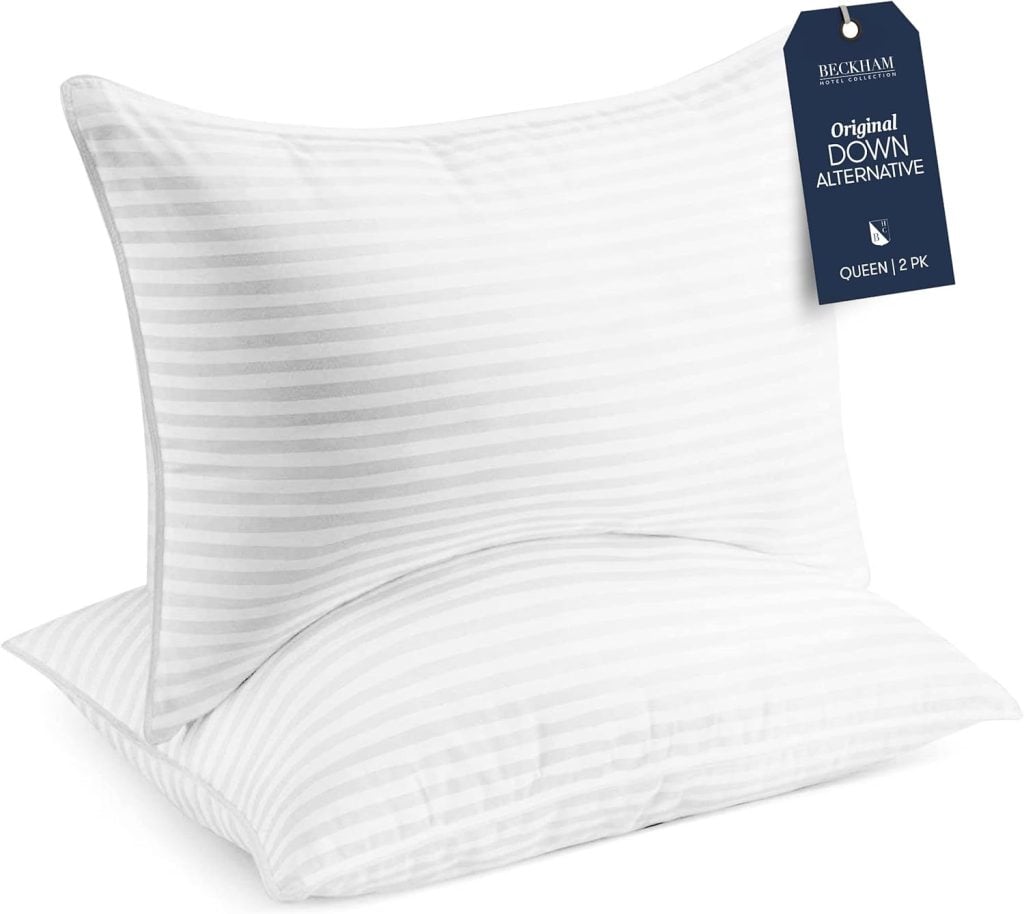 Two white striped pillows stacked, with a navy tag labeled "Original Down Alternative, Queen, 2 PK" attached—perfect for enhancing your Black Friday finds.