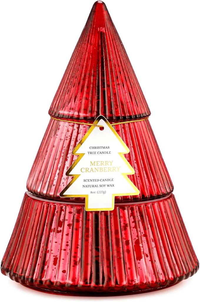 A red, glass, tree-shaped candle container labeled "Merry Cranberry Scented Candle, Natural Soy Wax, 8 oz" with a gold-trimmed Christmas tree tag, perfect for bringing cozy fragrance to your home during the holiday season.